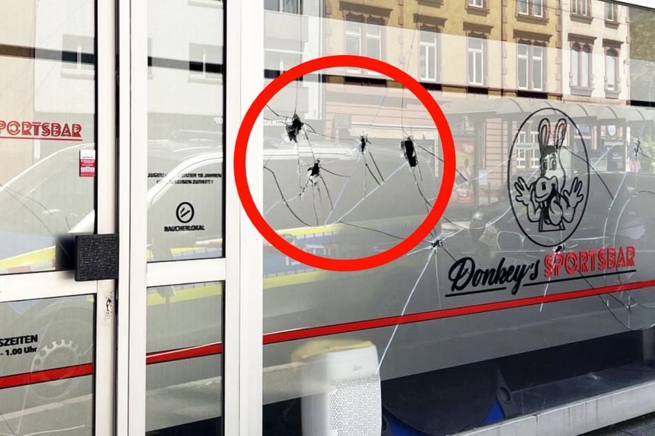 Wie das Bild zeigt, weist eine Glasscheibe von "Donkey's Sportsbar" in Frankfurt-Bornheim Beschädigungen auf, die an Einschusslöcher erinnern - wurden in der Rohrbachstraße Schüsse abgegeben?