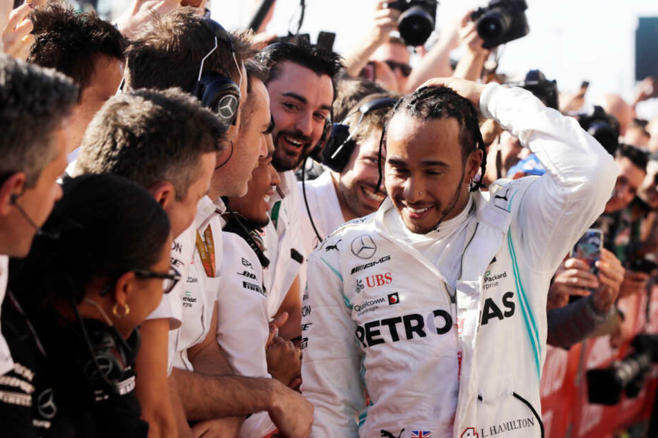 Der sechsmalige Weltmeister Lewis Hamilton aus Großbritannien von Team Mercedes wird von seinen Teamkollegen nach dem Rennen empfangen und beglückwünscht.