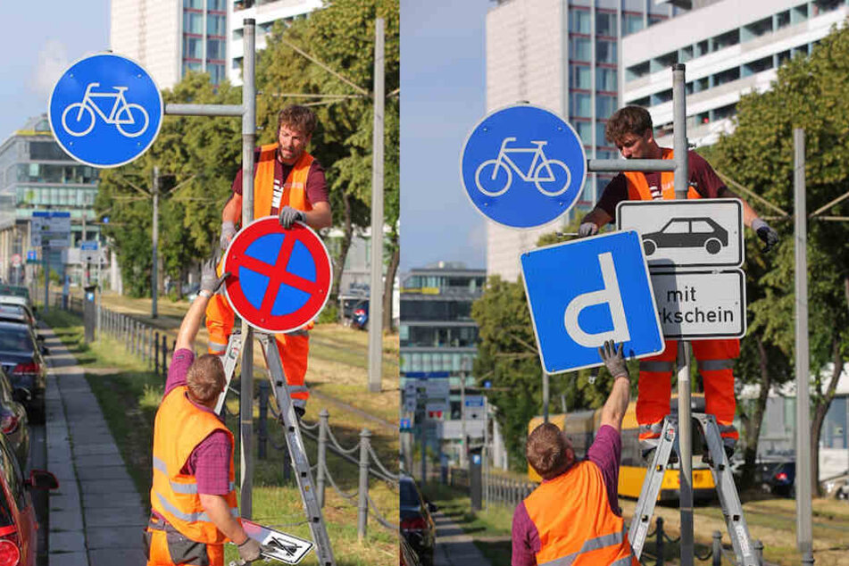 Die Arbeiter montieren die Schilder ab, die das Parken ausgewiesen haben.