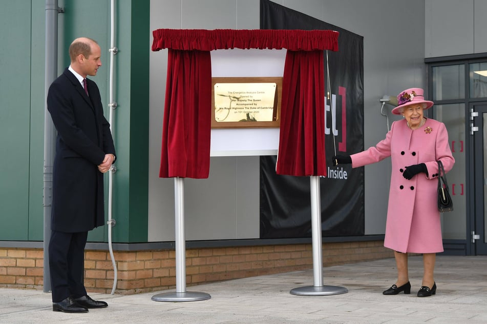 Prince William watches as Queen Elizabeth II unveils a plaque to officially open the new Energetics Analysis Centre at the Defence Science and Technology Laboratory.