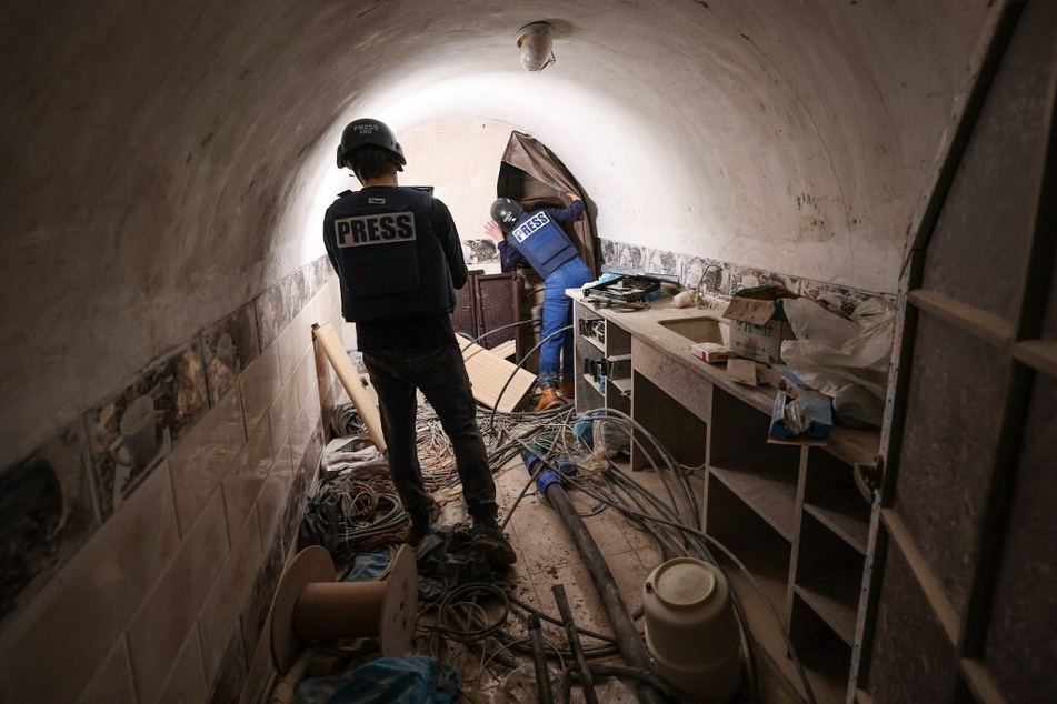 This picture taken during a media tour organized by the Israeli military on February 8, 2024, shows journalists inside a tunnel that the army claimed is a "Hamas command tunnel" under a compound of the United Nations Relief and Works Agency for Palestine Refugees in Gaza City.