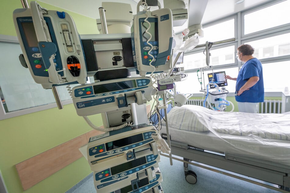 Chefarzt Lorenz Nowak steht an einer Maschine in einem Intensivbett-Zimmer der Asklepios Klinik in Gauting (Bayern).