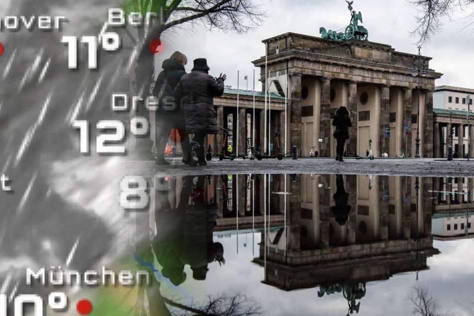 Das Brandenburger Tor spiegelt sich in einer Regenpfütze.