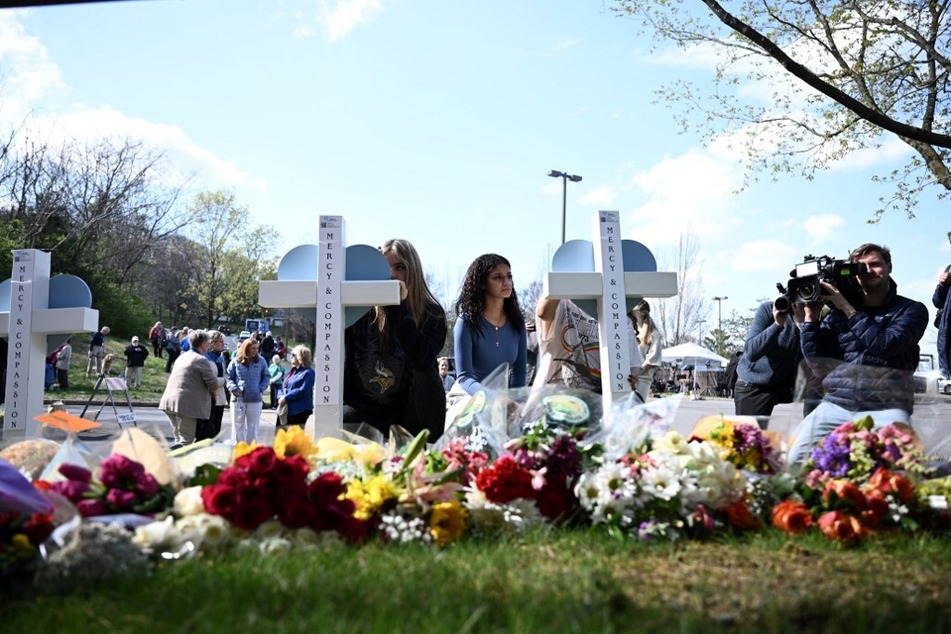 People pay their respects at a makeshift memorial for victims at the Covenant School building at the Covenant Presbyterian Church following a shooting, in Nashville, Tennessee