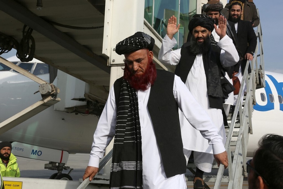 Abdul Karim (l.) and Abdul Zahir (c.), who were held for years at the infamous US detention center in Guantanamo Bay, arrive at the Kabul airport in Afghanistan on February 12, 2024.