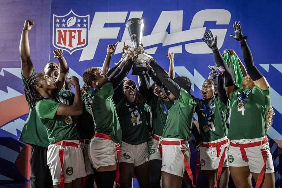 Players of Nigeria’s national women’s senior flag football team lift the trophy as they celebrate their tournament victory during the NFL Flag Africa Continental Championships at Nyayo Stadium in Nairobi, Kenya, on July 10, 2026.