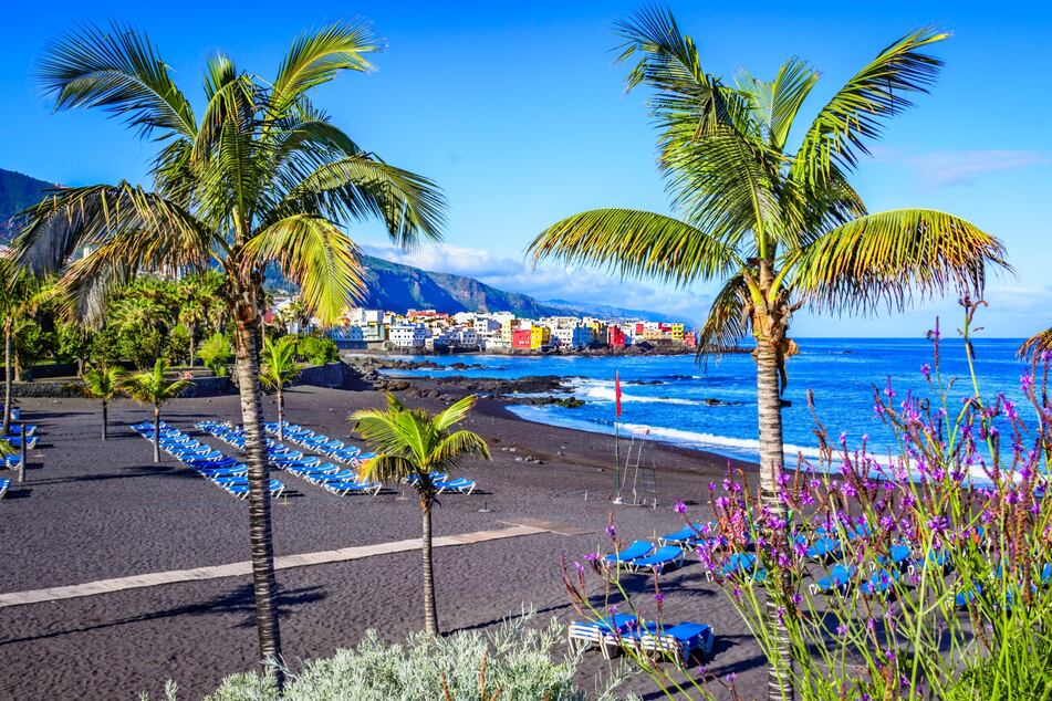 Berühmter Strand Playa Jardin auf Teneriffa in Puerto de la Cruz mit schwarzem Sand an einem schönen Tag.