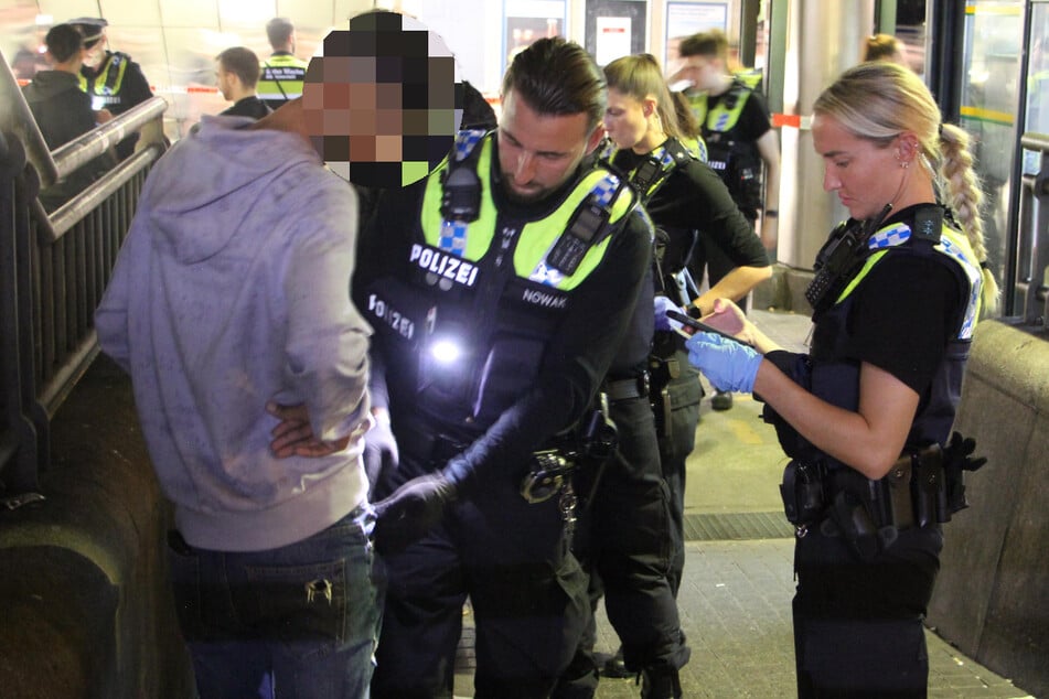 Officers check a young man at Hamburg Central Station. Is he hiding a knife in his trouser pocket?