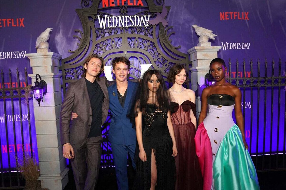 Percy Hynes White (l) and the cast of the hit show Wednesday.