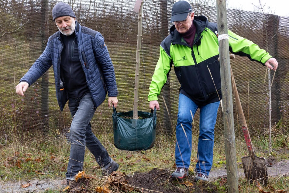 Mitinitiator Ralf-Uwe Beck (l) und Bodo Ramelow (68, Linke), geschäftsführender Thüringer Ministerpräsident, unterstützen die Baumpflanzaktion am Baumkreuz entlang des hier noch stehenden Grenzzauns an der ehemaligen deutsch-deutschen Grenze.