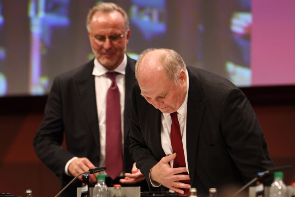 Karl-Heinz Rummenigge (l.) übernimmt das Rednerpult, während Uli Hoeneß sich dankend vor den Zuschauern verbeugt.