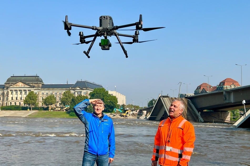 Horst Ullrich (62, l.), Fachexperte Hochwasservorsorge beim Umweltamt, und Jens Focke (59), Abteilungsleiter Geodatenerfassung der Stadt Dresden, erklären die Aufgaben der Drohne bei einer Pressekonferenz.