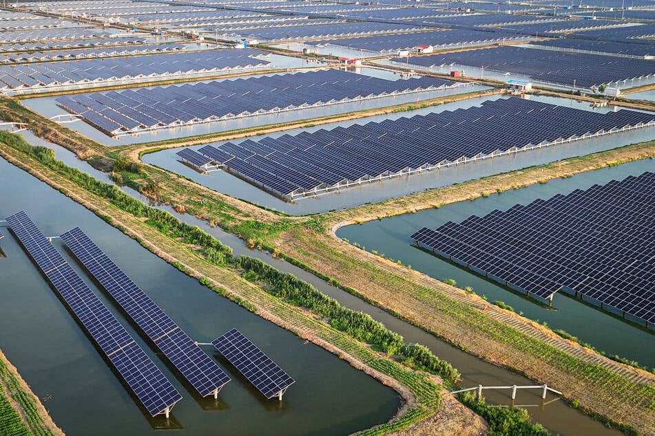 An aerial view shows solar panels at the fishing-solar complementary photovoltaic power generation base in Lianyungang, in eastern China's Jiangsu province on July 31, 2024.