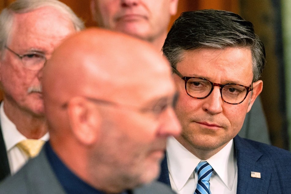 Speaker of the House Mike Johnson looks on as Rep. Clay Higgins speaks during a news conference at the US Capitol in Washington DC on May 15, 2024.