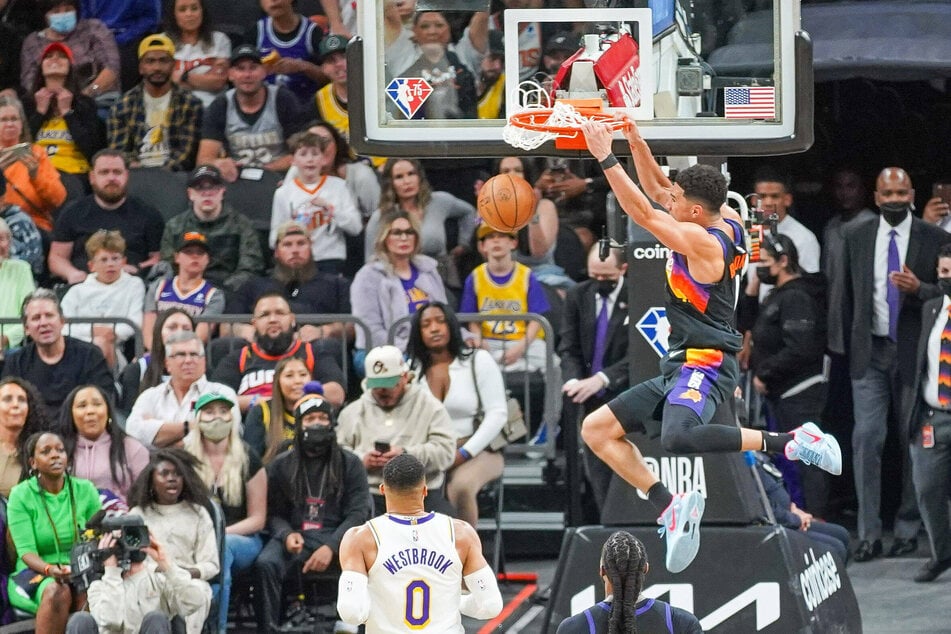Devin Booker dunking on the Lakers during the Suns' big win.
