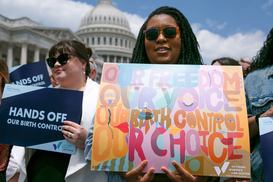 Supporters of expanded access to contraception hold signs during a press conference outside of the US Capitol in Washington DC.