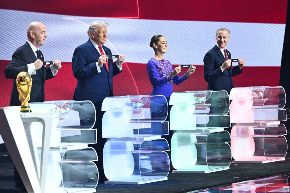 (From L) FIFA President Gianni Infantino, US President Donald Trump, Mexico's President Claudia Sheinbaum, and Canada's Prime Minister Mark Carney pose with their cards during the draw for the 2026 FIFA Football World Cup taking place in the US, Canada, and Mexico, at the Kennedy Center, in Washington, DC, on Friday.