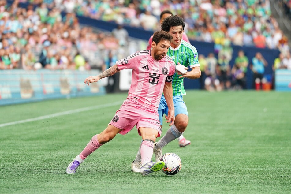 Lionel Messi of Inter Miami CF is challenged by Paul Rothrock of the Seattle Sounders FC during the Leagues Cup Final.