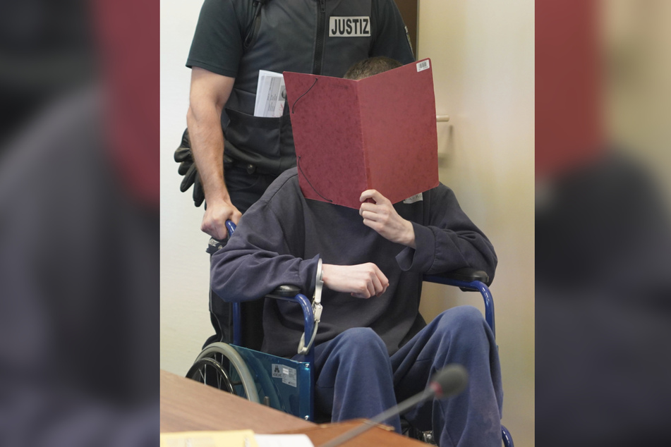 Der 29-Jährige wurde in einem Rollstuhl in den Gerichtssaal geschoben.