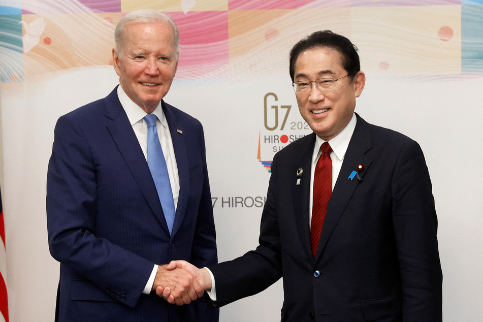 US President Joe Biden and Japan's Prime Minister Fumio Kishida shake hands prior to a bilateral meeting ahead of the G7 leaders' summit in Hiroshima.