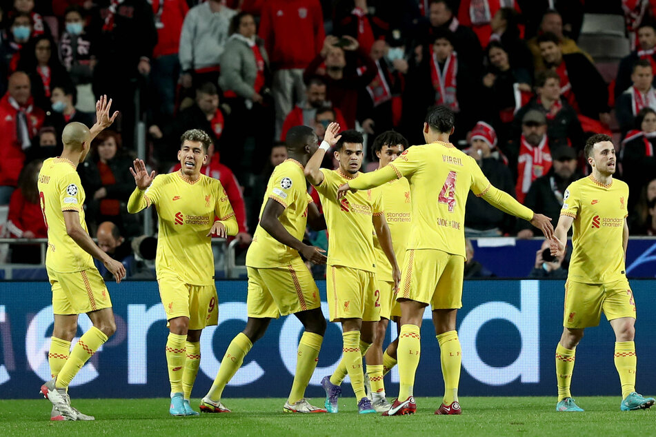 Liverpool players celebrate Luis Diaz's late goal that sealed a 3-1 win at Benfica.