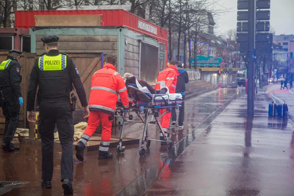 Rettungskräfte transportieren den Leichnam in das Institut für Rechtsmedizin.