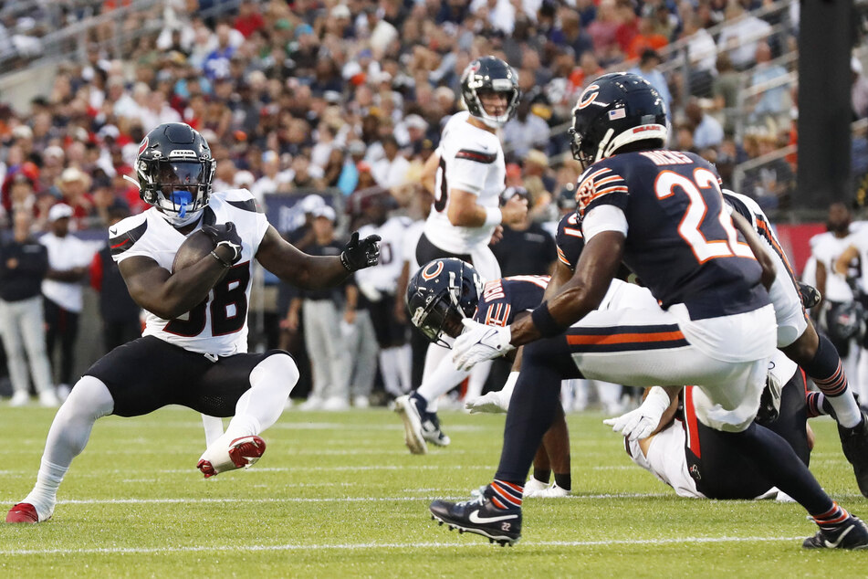 Houston Texans running back J.J. Taylor carries the ball against the Chicago Bears during the first quarter at Tom Benson Hall of Fame Stadium.