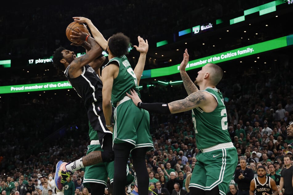 Kyrie Irving gets shut down by Celtics guard Derrick White.