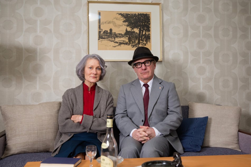 Die Schauspieler Hedi Kriegeskotte (72) und Jörg Schüttauf (59) in den Rollen von Margot und Erich Honecker sitzen in einem Wohnzimmer bei den Dreharbeiten zur Krimikomödie "Vorwärts immer". Kriegeskotte ist im neuen ZDF-Drama "Bring mich nach Hause" als sprachlose Komapatientin zu sehen. (Archivbild)