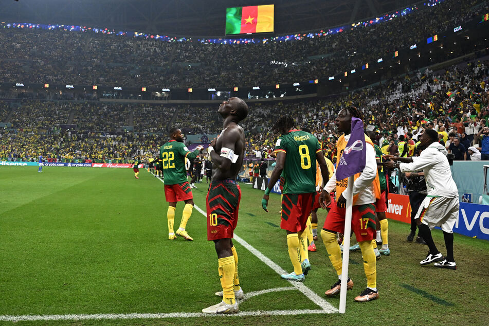 Vincent Aboubakar (c.) celebrates his winning goal against Brazil.