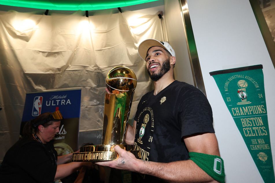 Boston Celtics forward Jayson Tatum holds the Larry O’Brien Championship Trophy after their win against the Dallas Mavericks in the 2024 NBA Finals at TD Garden.