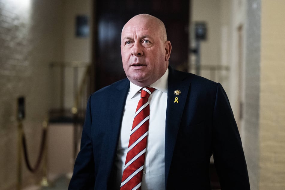 A congressional staffer was pictured next to an American flag with a swastika in the middle that was pinned up in the Washington DC office of Representative Dave Taylor.