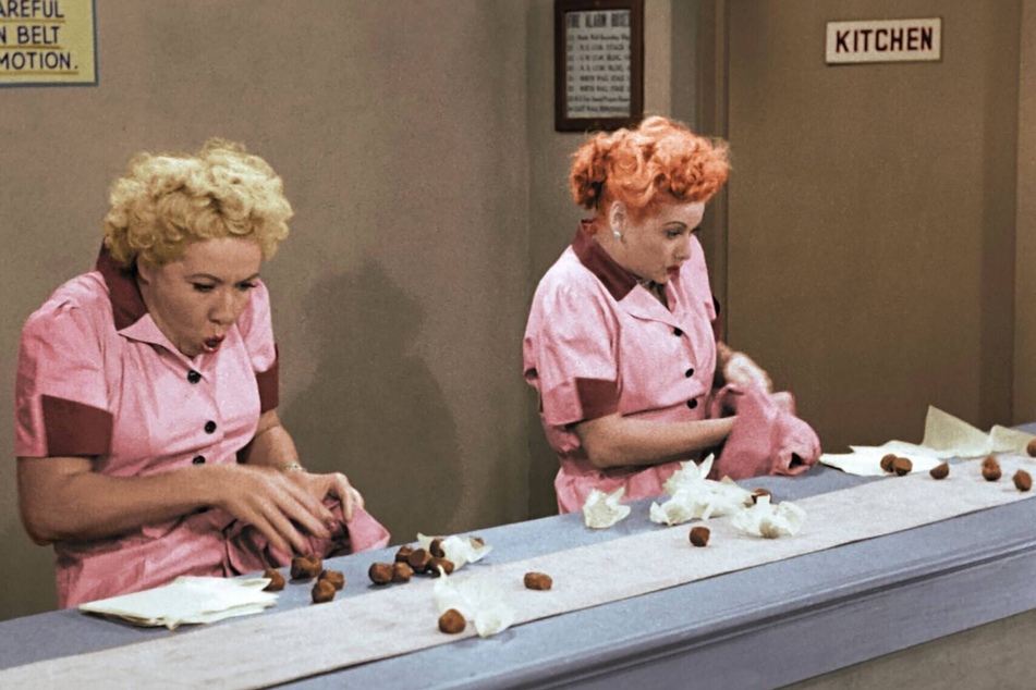 Ethel Mertz (Vivian Vance) and Lucy Ricardo (Lucille Ball) gobble down See's chocolates in the Job Switching episode of I Love Lucy, first aired in 1952.