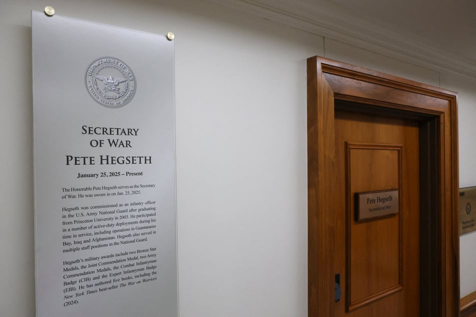 A plaque and a sign that read "Pete Hegseth – Secretary of War" hang at the Pentagon after President Donald Trump ordered the Department of Defense to be renamed as the "Department of War."