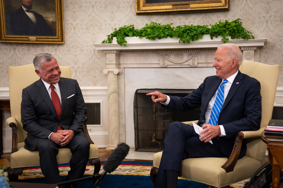 His Majesty King Abdullah II Ibn Al Hussein, King of the Hashemite Kingdom of Jordan (l.), and United States President Joe Biden sit during a meeting inside the Oval Office.