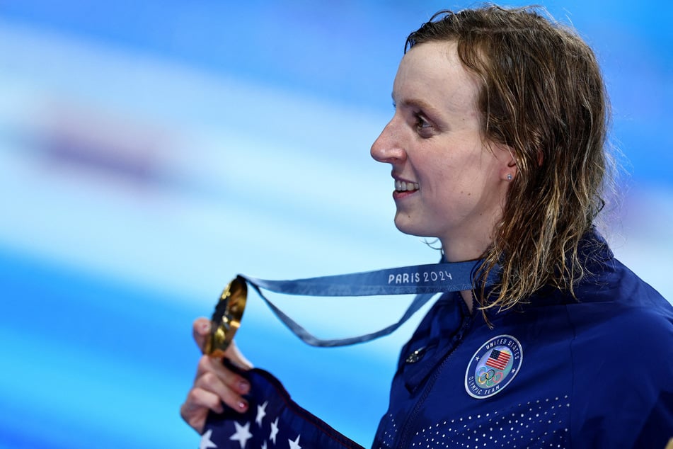 Team USA's Katie Ledecky celebrates with her gold medal after winning the women's 800m freestyle race at the Paris Olympics.