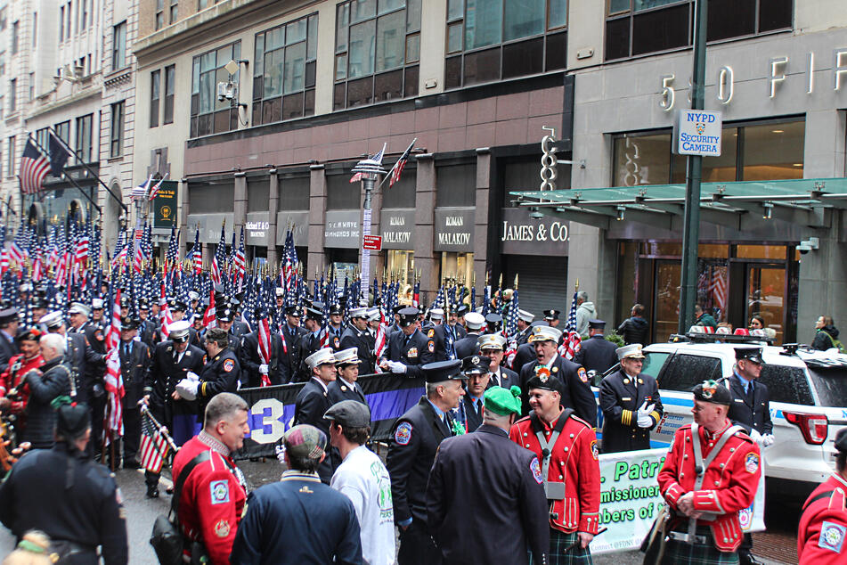 Shortly before the parade is scheduled to begin, participants gather and prepare to head out to Fifth Ave.