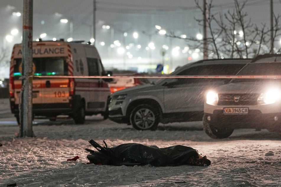 Eine Leiche in einem Plastiksack liegt nach einem russischen Angriff in Kiew auf dem Boden.