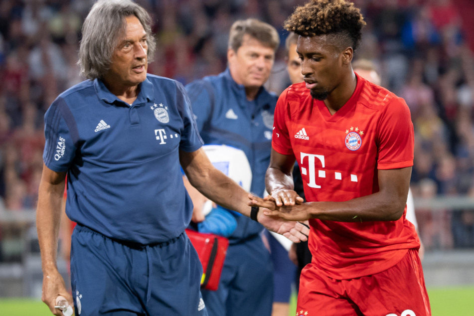 Kingsley Coman (r) wird nach einem Foul von Mannschaftsarzt Hans-Wilhelm Müller-Wohlfahrt (77) behandelt.