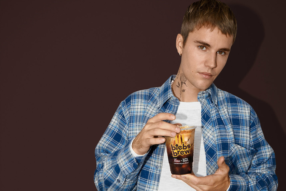 Justin Bieber showing off Tim Horton's Bieber Brew.