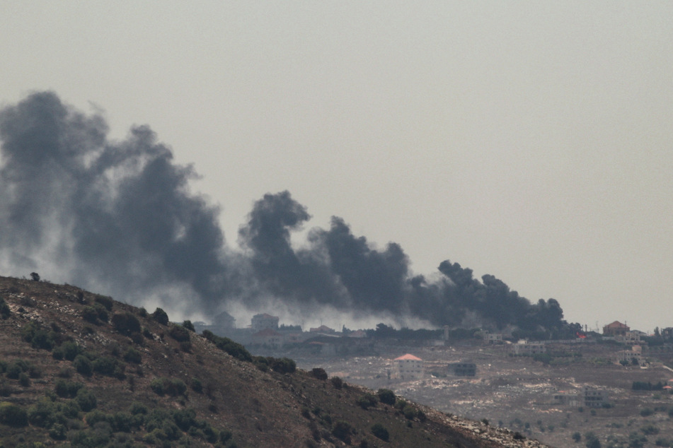 Smoke billows from the site of an Israeli strike on the southern Lebanese village of Taybeh on Sunday, amid ongoing cross-border clashes between Israeli troops and Lebanon's Hezbollah fighters.