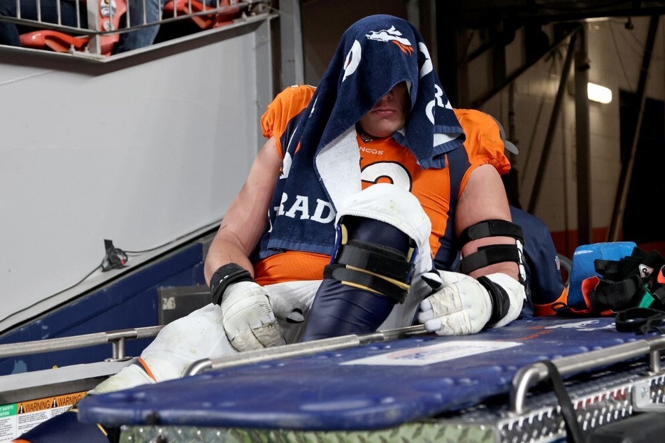 Garett Bolles of the Denver Broncos is carted off the field during a game against the Indianapolis Colts at Empower Field At Mile High Stadium.