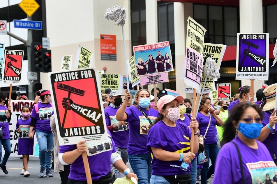 More than 1,000 janitors with the Service Employees International Union rally and march in Los Angeles in September 2021.