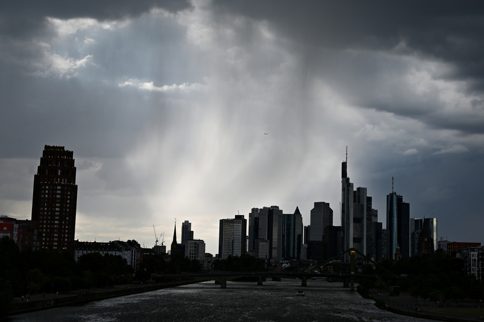 Dunkle Regenwolken ziehen über die Bankentürme von Frankfurt am Main.