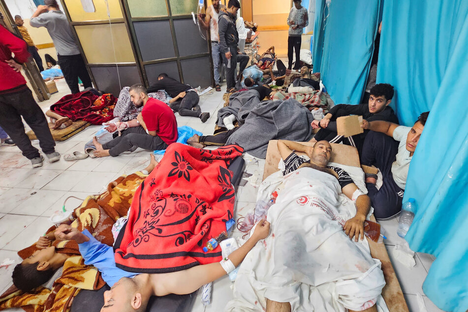 Palestinians wounded in Israeli strikes lie on the floor as they are assisted at the Indonesian hospital after Al Shifa hospital has gone out of service.
