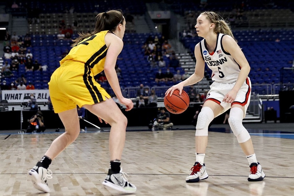 In their last matchup in 2021, UConn defeated Iowa in the Sweet 16 round of the March Madness tournament when Caitlin Clark (l.) and Paige Bueckers were both freshmen.