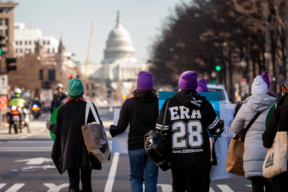 Protesters march to the Department of Justice to demand action on the ERA on January 27, 2022.