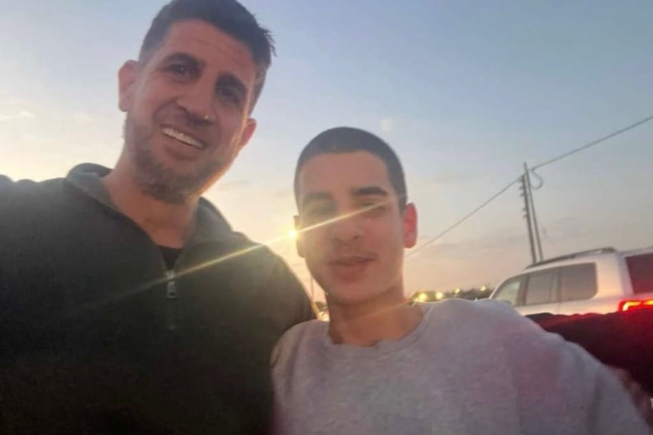 Mohammed Zaher Ibrahim (r.) reunites with his father after his release from Israel's Ofer prison.