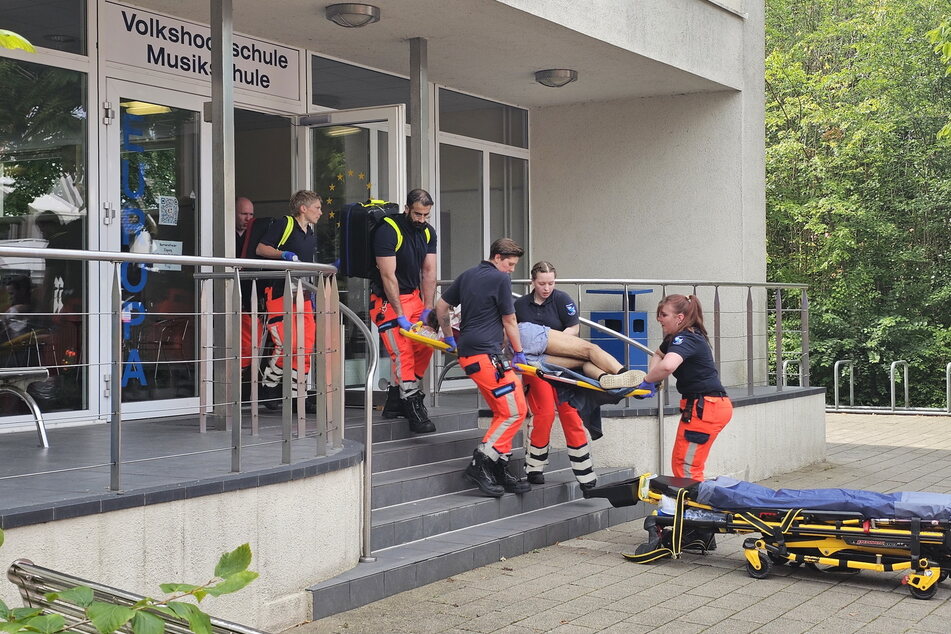 Eine verletzte Person wird von den Rettungskräften aus der Schule getragen.