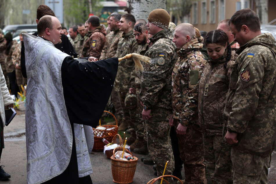 A priest blessed traditional cakes and eggs during a church service with troops on the eve of the Orthodox Easter on Saturday in the eastern Ukrainian city of Sloviansk, amid the Russian invasion of Ukraine.
